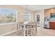 Bright dining area with table and chairs,wood flooring, and access to a patio at 1493 Janet Pl, Englewood, FL 34223