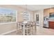 Cozy dining area featuring a kitchen view, and natural light from a large window, providing a comfortable space at 1493 Janet Pl, Englewood, FL 34223