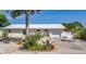 White single story home with attached garage and palm trees at 1493 Janet Pl, Englewood, FL 34223