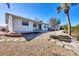 Backyard view of house with sloped landscaping and fire pit at 1493 Janet Pl, Englewood, FL 34223