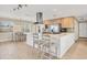 Open-concept kitchen with stainless steel appliances, island seating, and pendant lighting at 1493 Janet Pl, Englewood, FL 34223