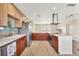 Modern kitchen with an island and wood cabinets at 1493 Janet Pl, Englewood, FL 34223