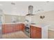 Modern kitchen with stainless steel appliances and wood cabinets at 1493 Janet Pl, Englewood, FL 34223