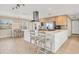 Modern kitchen with white cabinets, stainless steel appliances, and an island at 1493 Janet Pl, Englewood, FL 34223