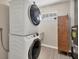 Laundry room with stackable washer and dryer, plus extra storage at 1493 Janet Pl, Englewood, FL 34223