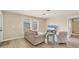 Cozy living area with comfortable seating and natural light from the window at 1493 Janet Pl, Englewood, FL 34223