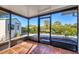 Relaxing screened porch with terracotta tile floor and backyard view at 1493 Janet Pl, Englewood, FL 34223