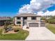 Stunning two-story home with a three-car garage and manicured landscaping at 15064 Hennipen Cir, Port Charlotte, FL 33981