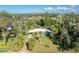 Aerial view of a light blue house, lush landscaping, and neighborhood at 1770 Hudson St, Englewood, FL 34223