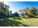 Large backyard with home and screened patio at 1770 Hudson St, Englewood, FL 34223