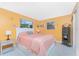 Bedroom with a double bed, peach bedding, and yellow walls at 1770 Hudson St, Englewood, FL 34223