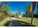 View of the home from the driveway, showcasing the front yard at 1770 Hudson St, Englewood, FL 34223