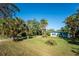 Cute blue house with palm trees and grassy yard at 1770 Hudson St, Englewood, FL 34223
