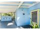 Inviting light blue home exterior with a yellow door and covered entryway at 1770 Hudson St, Englewood, FL 34223