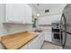 Galley style kitchen featuring stainless steel appliances and white cabinets at 1770 Hudson St, Englewood, FL 34223