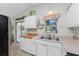 Bright kitchen features wood countertops, white cabinets, and a double sink at 1770 Hudson St, Englewood, FL 34223