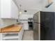 Efficient kitchen with wood countertops and stainless steel appliances at 1770 Hudson St, Englewood, FL 34223