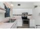 Classic kitchen with white cabinets, updated appliances, and ample counter space at 1770 Hudson St, Englewood, FL 34223