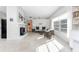 Bright living room features a fireplace and comfy wicker furniture at 1770 Hudson St, Englewood, FL 34223