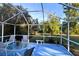 Spacious screened-in porch with seating and backyard view at 1770 Hudson St, Englewood, FL 34223