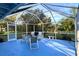 Enjoy this screened porch with seating and a view of the backyard at 1770 Hudson St, Englewood, FL 34223