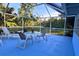 Screened porch with table and chairs, overlooking the backyard at 1770 Hudson St, Englewood, FL 34223
