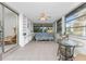 Bright sunroom with built-in shelving, sofa, and glass table at 1770 Hudson St, Englewood, FL 34223