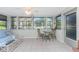 Relaxing sunroom with tiled floors, comfy seating, and a glass-top table at 1770 Hudson St, Englewood, FL 34223