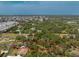 Aerial view of property line and home's surroundings showing homes and trees at 1828 Whispering Pines Cir, Englewood, FL 34223