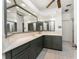 Spacious bathroom with large mirrors, lots of storage and neutral tiling at 1828 Whispering Pines Cir, Englewood, FL 34223