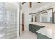 Bathroom with a glass block shower, vanity with lots of storage and neutral tiling at 1828 Whispering Pines Cir, Englewood, FL 34223