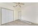 Bright bedroom with ceiling fan, closet, and light wood-look flooring at 1828 Whispering Pines Cir, Englewood, FL 34223
