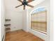 Bright bedroom features hard wood floors, a window and shelving at 1828 Whispering Pines Cir, Englewood, FL 34223