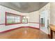 Charming dining room with hardwood floors, decorative wallpaper, and natural light, perfect for Gathering meals at 1828 Whispering Pines Cir, Englewood, FL 34223