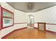 Inviting dining room with hardwood floors, decorative wallpaper, and a vintage-style ceiling, perfect for entertaining guests at 1828 Whispering Pines Cir, Englewood, FL 34223