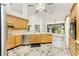 Bright kitchen features tile flooring, wooden cabinetry, stainless steel appliances, and lots of light at 1828 Whispering Pines Cir, Englewood, FL 34223