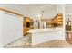 Open kitchen featuring a breakfast bar, stainless steel appliances, and tile floors at 1828 Whispering Pines Cir, Englewood, FL 34223