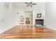 Large living room featuring hardwood floors, a decorative fireplace, and an open layout, ideal for gatherings at 1828 Whispering Pines Cir, Englewood, FL 34223
