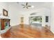 Spacious living room with hardwood floors, a fireplace, and views of the screened lanai, great for relaxing at 1828 Whispering Pines Cir, Englewood, FL 34223