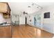 Bright room with hardwood floors, bar and light from sliding glass doors at 1828 Whispering Pines Cir, Englewood, FL 34223