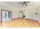 Bright living room featuring hardwood floors, ceiling fan and door leading to an outdoor space at 1828 Whispering Pines Cir, Englewood, FL 34223