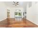Open living room with hardwood floors, high ceilings, and views of the screened lanai, perfect for entertaining at 1828 Whispering Pines Cir, Englewood, FL 34223