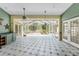 Screened-in porch with tile floors, overhead fans, and decorative accents at 1828 Whispering Pines Cir, Englewood, FL 34223