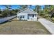 Cute light blue house with driveway and fenced yard at 18302 Gypsy Ave, Port Charlotte, FL 33954