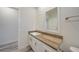 Bathroom with white vanity, wood countertop and double mirrors at 18302 Gypsy Ave, Port Charlotte, FL 33954