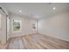 Well-lit bedroom with wood-look floors and two windows at 18302 Gypsy Ave, Port Charlotte, FL 33954