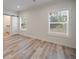 Charming bedroom with barn door, wood floors and window views at 18302 Gypsy Ave, Port Charlotte, FL 33954