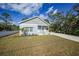 Newly constructed light blue home with white trim and porch at 18302 Gypsy Ave, Port Charlotte, FL 33954