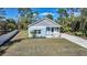 Newly built light blue home with a white fence and a spacious yard at 18302 Gypsy Ave, Port Charlotte, FL 33954