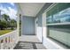 Quaint front porch with white railings and gray siding at 18302 Gypsy Ave, Port Charlotte, FL 33954